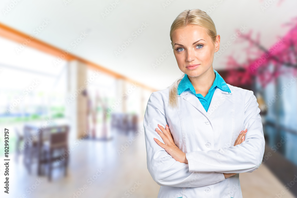 Beautiful smiling doctor woman in medical gown Beautiful smiling doctor woman in medical gown