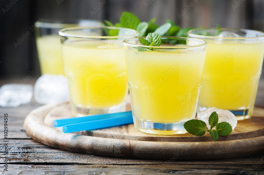 Yellow fresh cocktail with mint and ice Yellow fresh cocktail with mint and ice