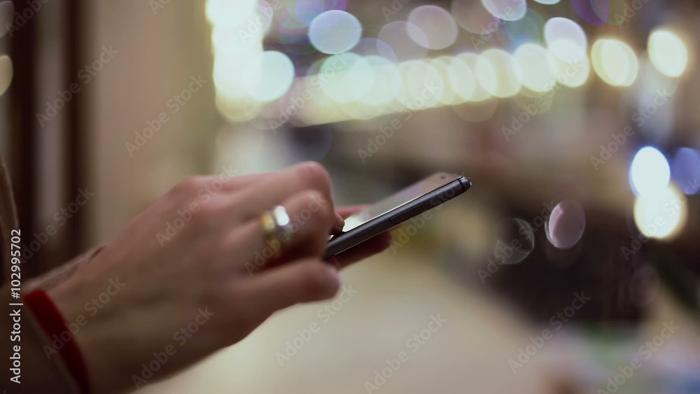 Woman hands texting, using smartphone in mall. 