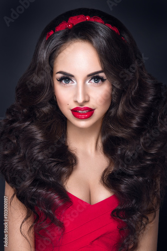 Fototapeta Naklejka Na Ścianę i Meble -  Beautiful woman portrait with excellent makeup and nice hairstyle. Red lipstick and red accessories  