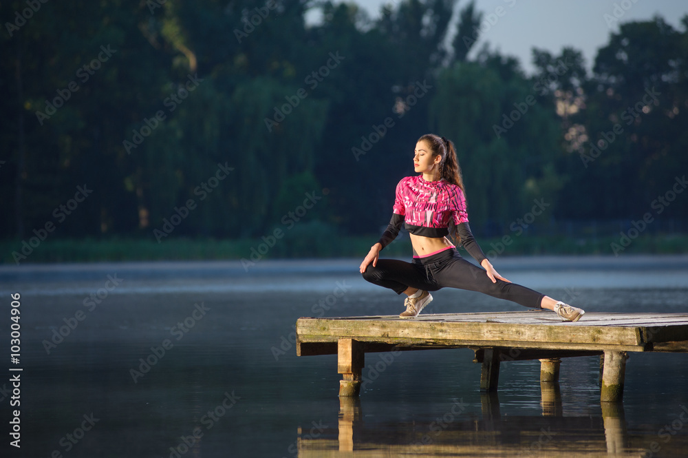 woman streching before her workout on the river