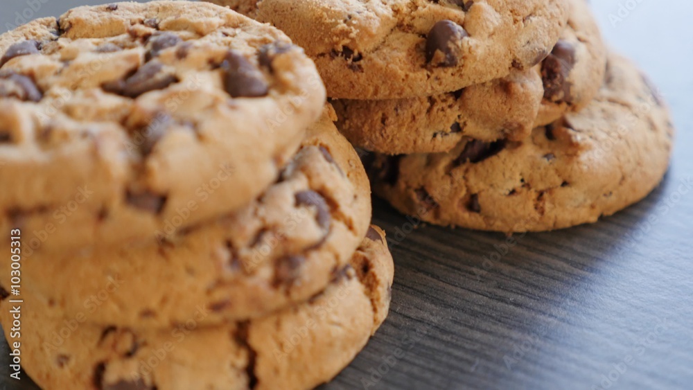 Cookies made of chocolate and flour arranged on table slow panning 4K 2160p UltraHD footage - Chocolate biscuit cookies on wooden surface 4K 3840X2160 UHD video