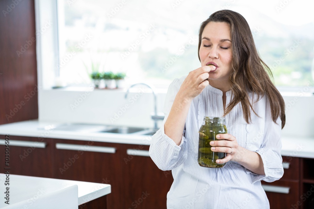 Pregnant woman eating pickles Pregnant woman eating pickles