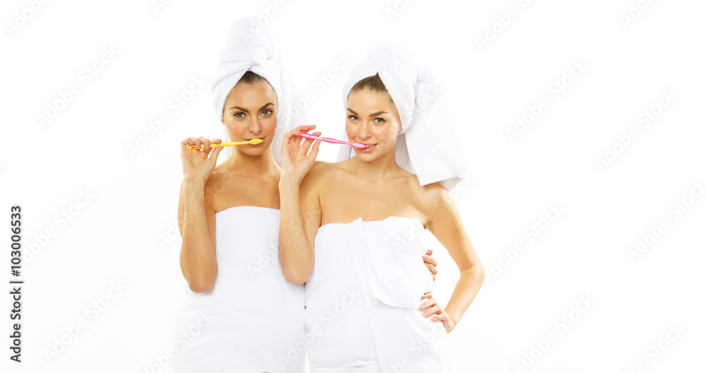 Two girls brush their teeth after shower Two girls brush their teeth after shower