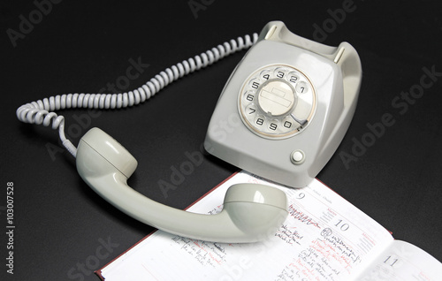 teléfono antiguo esfera gris descolgado sobre mesa negra 8400-f16 photo