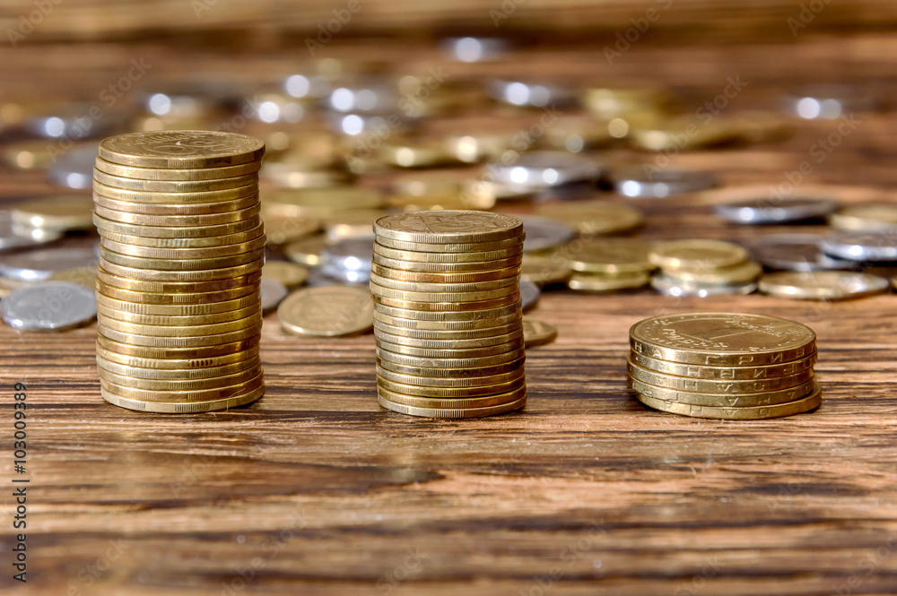 Coins stacked on wood Coins stacked on wood