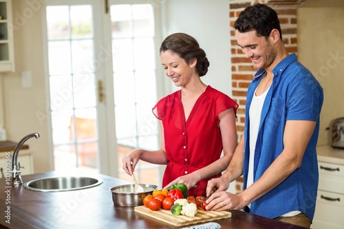 Young couple working together in kitchen