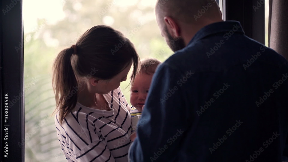 Young couple feeding baby at home
Young couple feeding baby at home