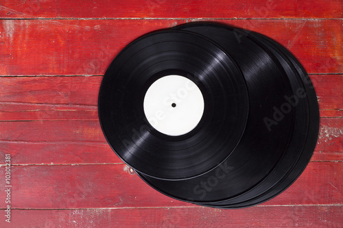 Vinyl records on wooden surface.
