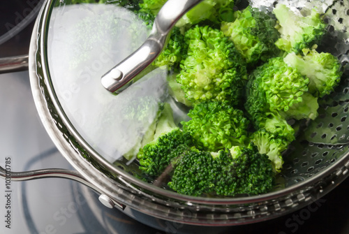 Freshly steamed green broccoli in skimmer pot