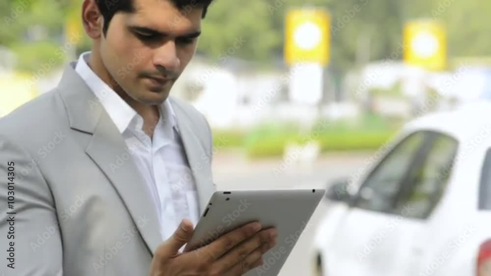 Locked-on shot of a businessman using a digital tablet Locked-on shot of a businessman using a digital tablet