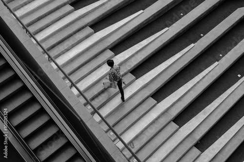 Man walking up the stairs motion blurred black and white
