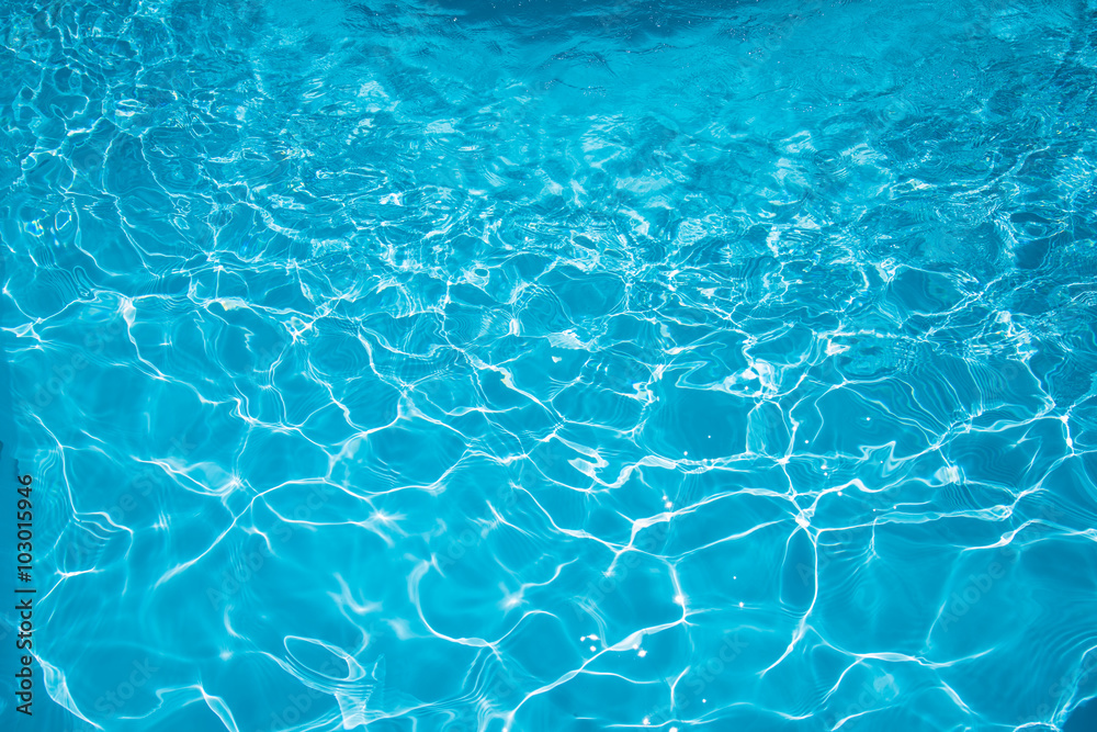 Beautiful ripple surface water in swimming pool with sun reflection