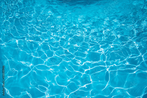 Beautiful ripple surface water in swimming pool with sun reflection