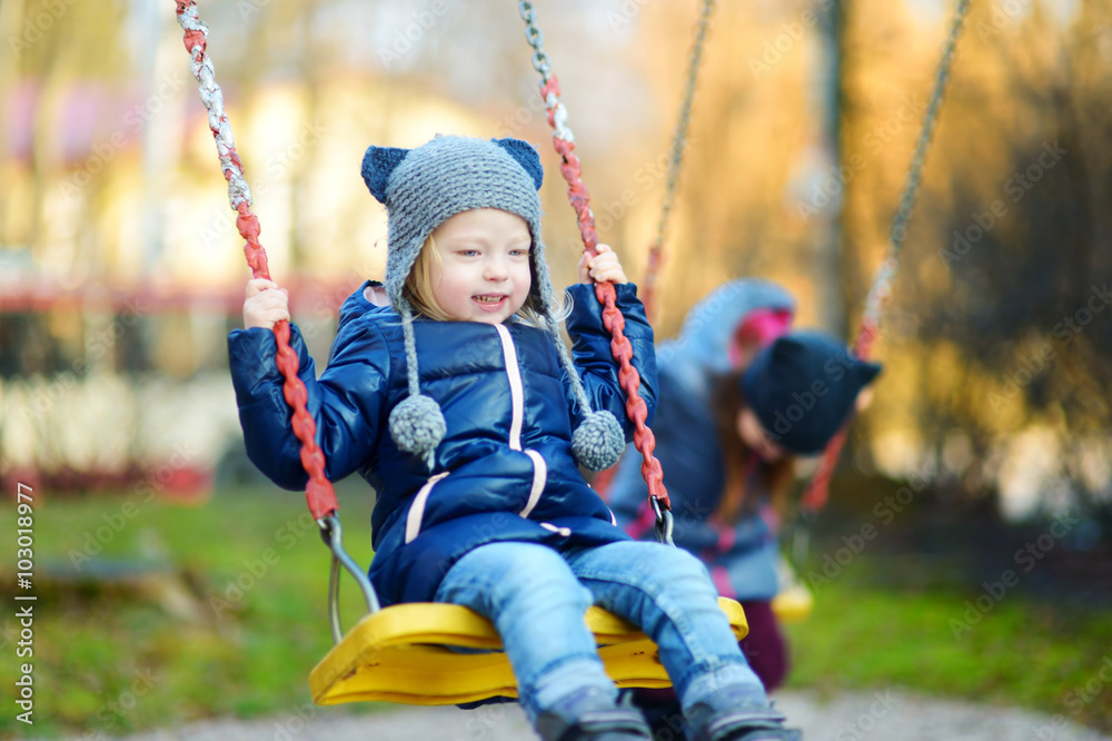 Cute little girl having fun on a swing Cute little girl having fun on a swing