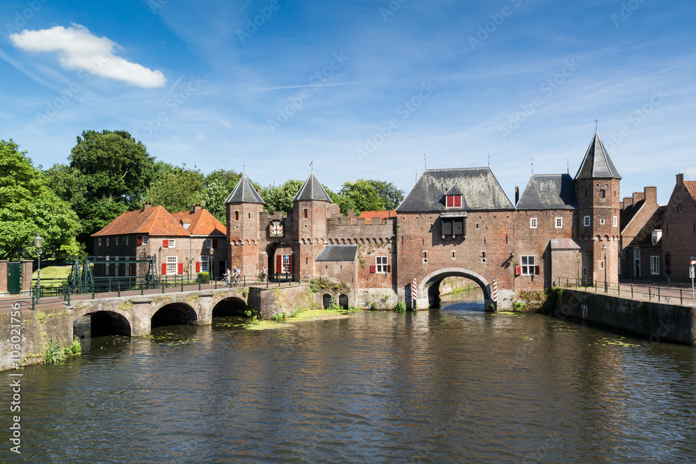 Medieval fortress city wall gate Koppelpoort and Eem River in the city of Amersfoort, Netherlands