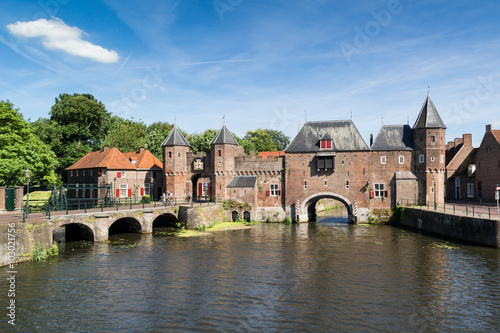 Medieval fortress city wall gate Koppelpoort and Eem River in the city of Amersfoort, Netherlands