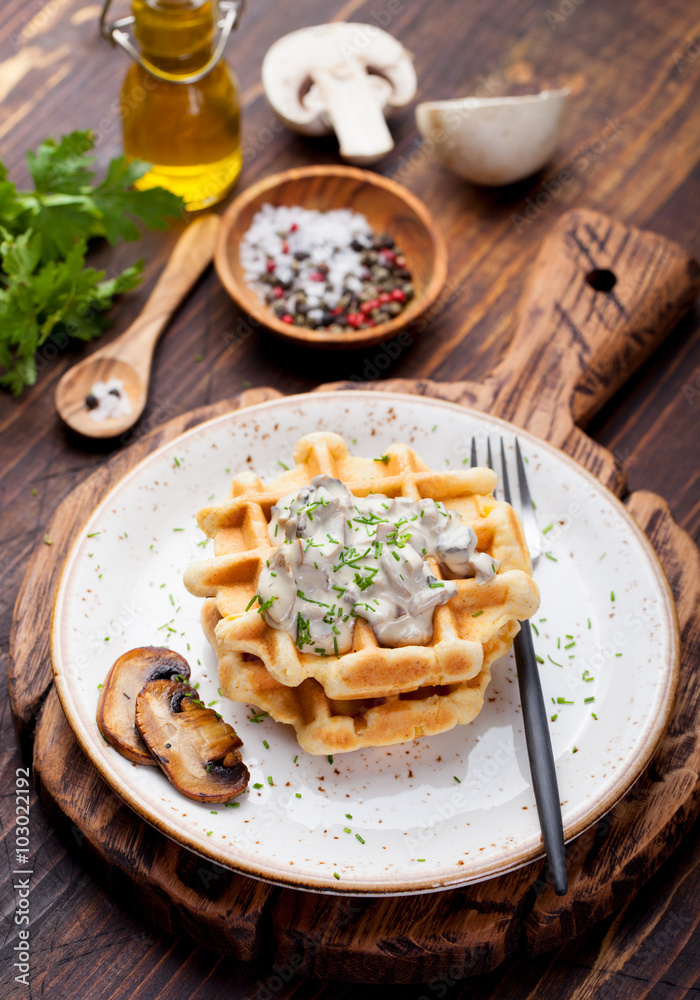 Savory waffles with corn and mushroom creamy sauce on a wooden background Top view Savory waffles with corn and mushroom creamy sauce on a wooden background Top view