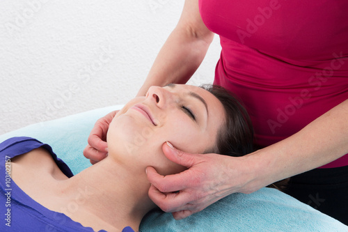 Beauty woman having cosmetic massage, facial treatment, close up.