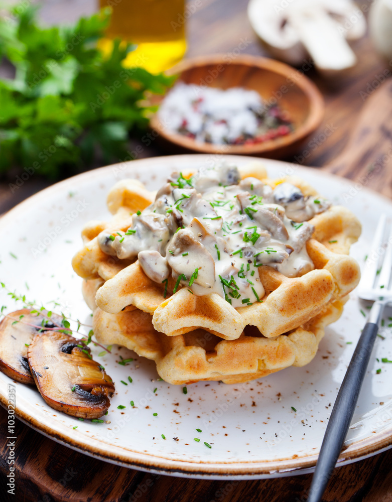 Savory waffles with corn and mushroom creamy sauce on a wooden background Savory waffles with corn and mushroom creamy sauce on a wooden background