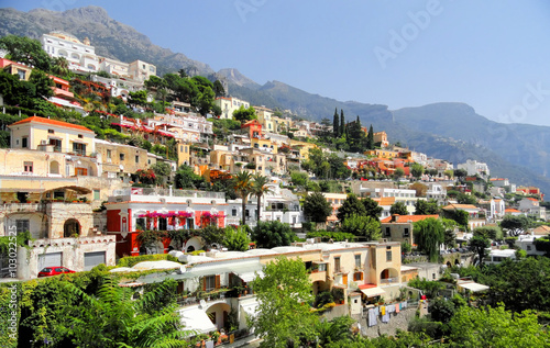 Positano Living    Red car driving through the colourful living area in the hills of Positano © tinasdreamworld