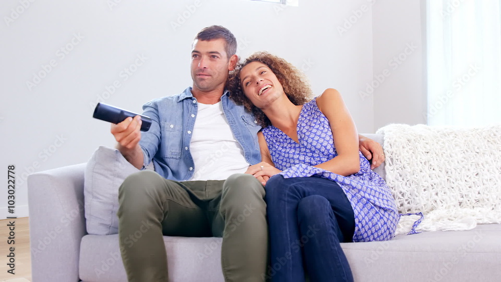 Cute young couple watching TV