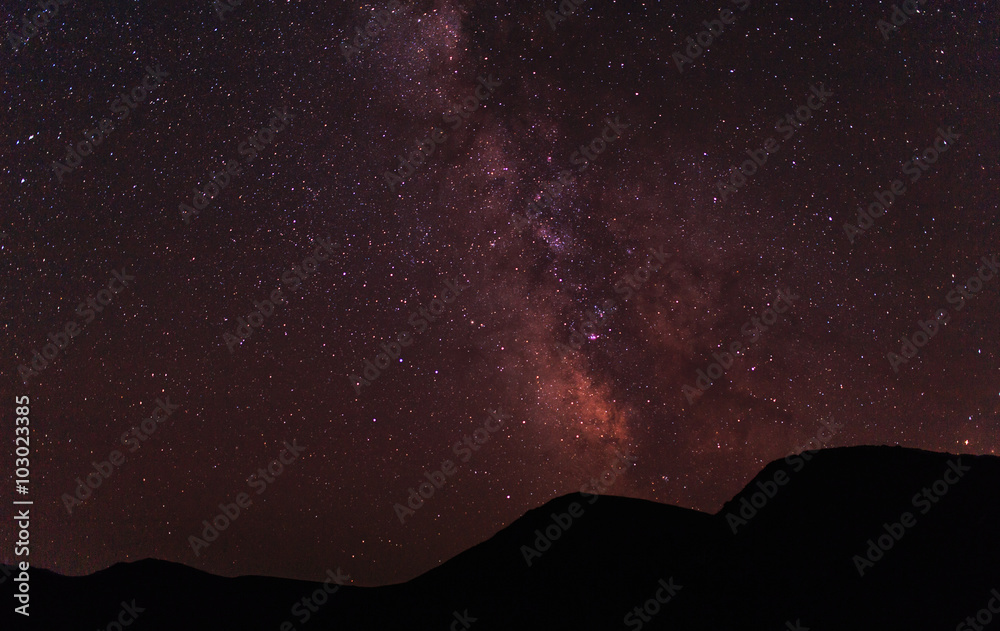 Vibrant night sky, milky way in mountains.