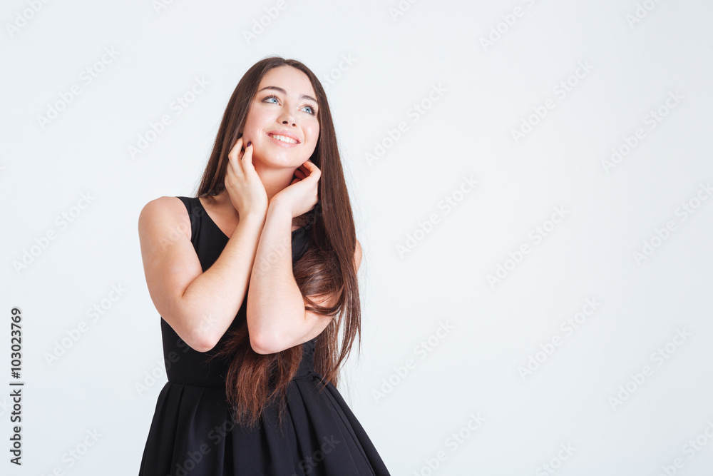 Inspired attractive young woman with long hair standing and dreaming Inspired attractive young woman with long hair standing and dreaming