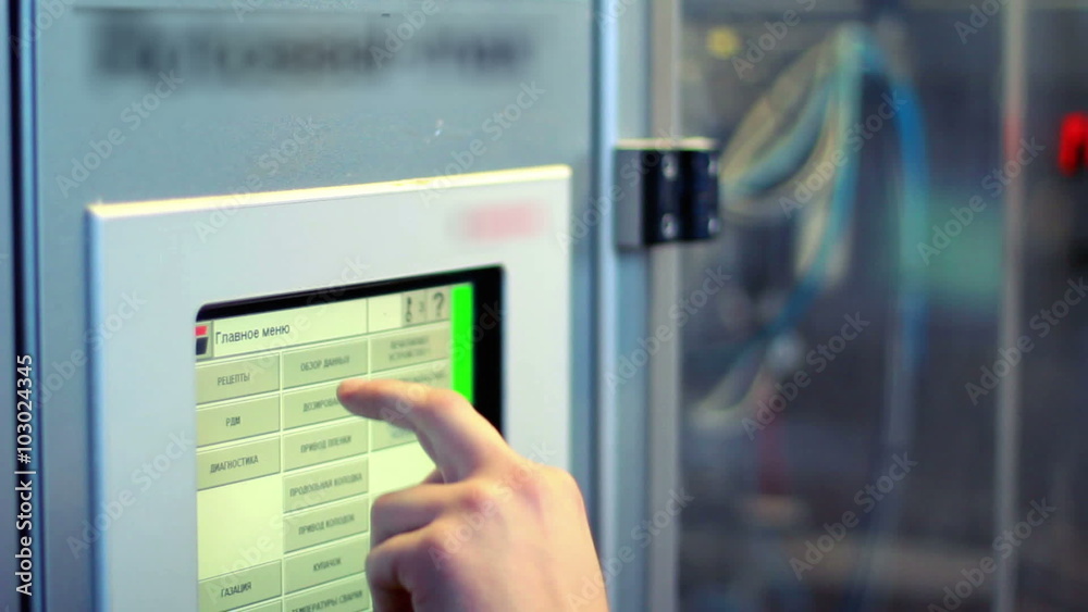 Industrial control panel display closeup/Modern industrial equipment/Worker operates computer controlled production line/Finger touch screen of cnc machine/Industrial computer equipment
