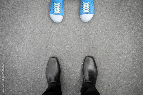 Black shoes standing opposite blue shoes