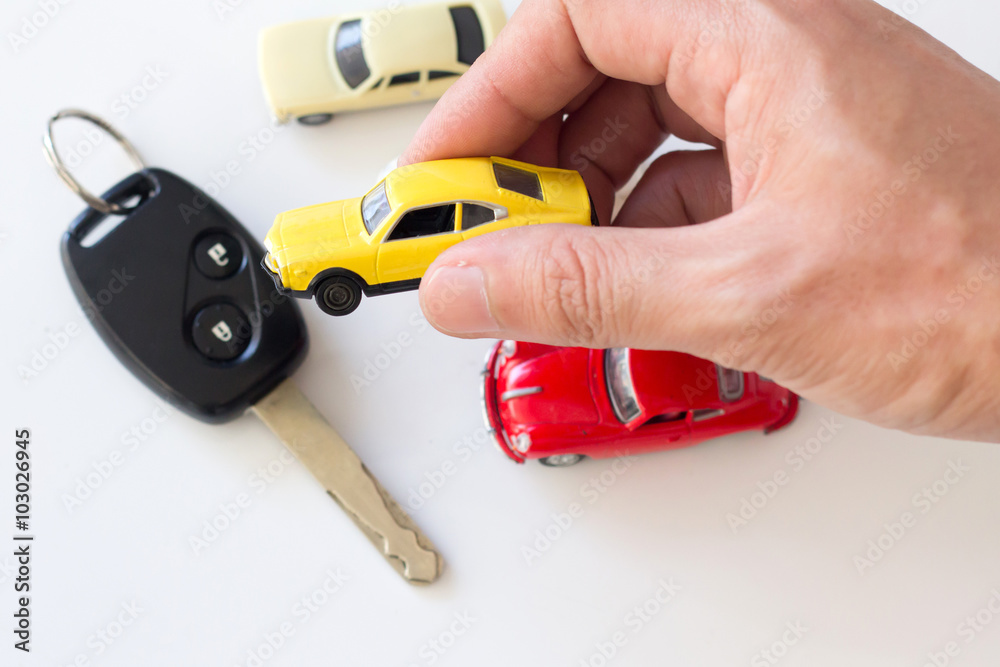 hand hold a car toy , car loan and car leasing concept. hand hold a car toy , car loan and car leasing concept.