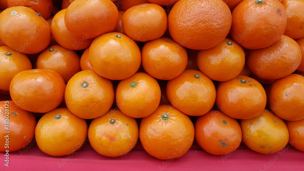 pile of fresh oranges for sele in market.