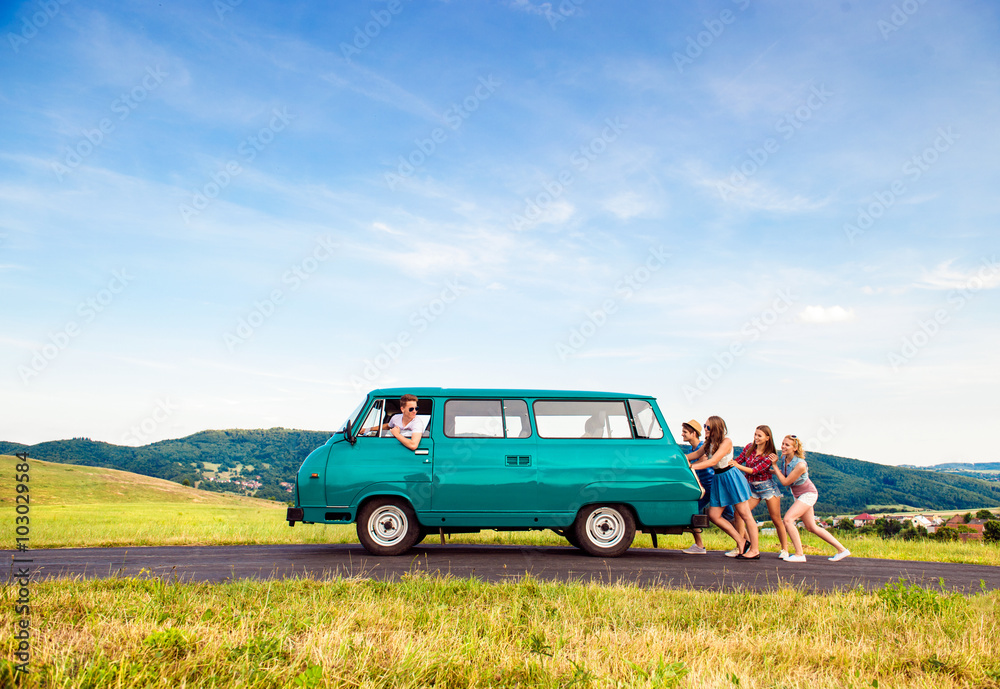 Jumping frieds with campervan, green nature and blue sky Jumping frieds with campervan, green nature and blue sky