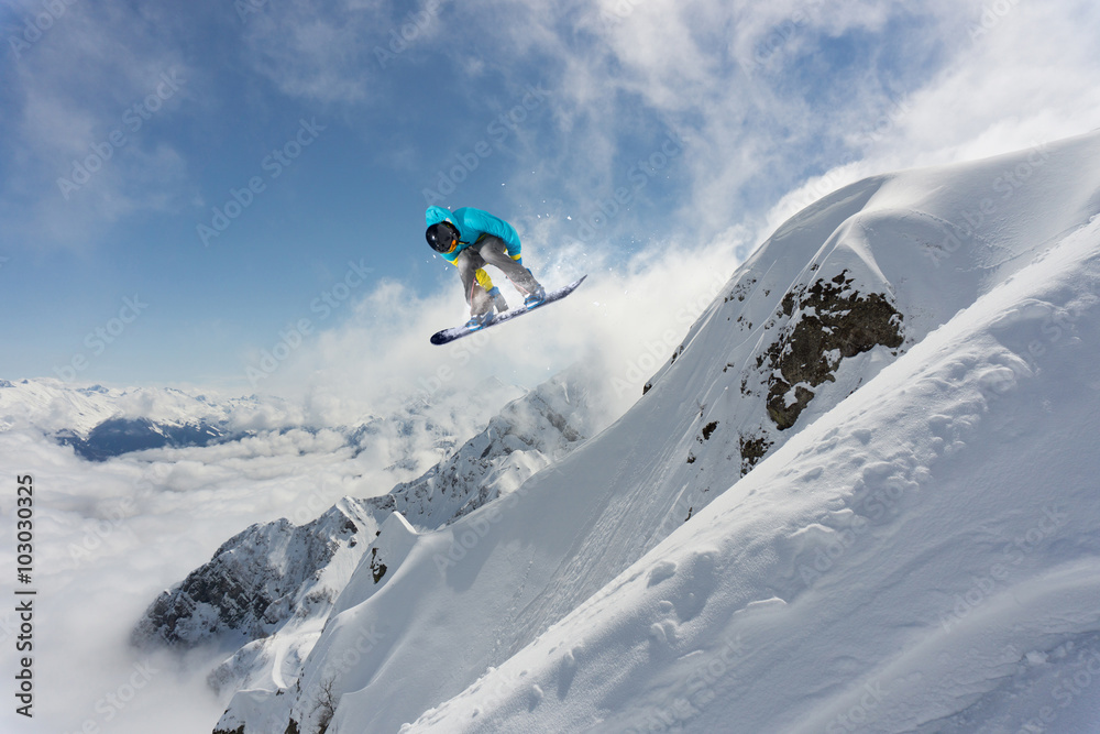 Flying snowboarder on mountains. Extreme sport. Flying snowboarder on mountains. Extreme sport.