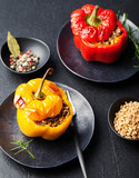 Baked stuffed bell peppers filled with spelt wheat, rice, vegetables Stone background
