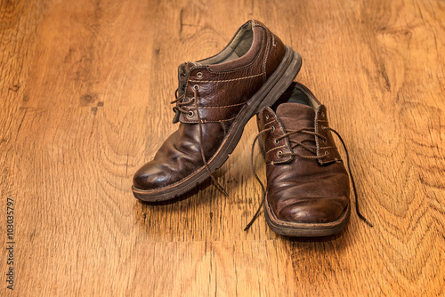 Men's old boots on wood background