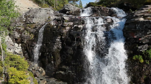 Beautiful waterfall in the Khibiny mountain at summer season, rapid water falling down from rock. Kuniyok valley, Khibins, Kola peninsula, Russia photo