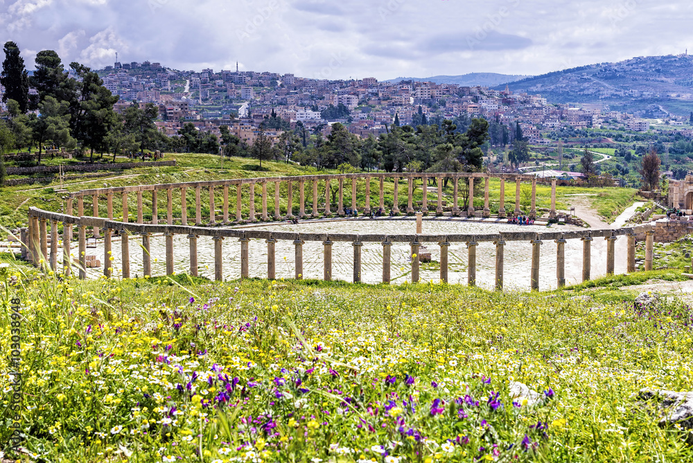 View of the Oval Forum colonnade in ancient Jerash, Jordan - Jerash is the site of the ruins of the Greco-Roman city of Gerasa, one of the best preserved Roman cities in the Middle East.