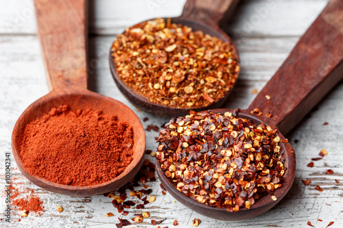 Different types of chilli flakes and paprika photo