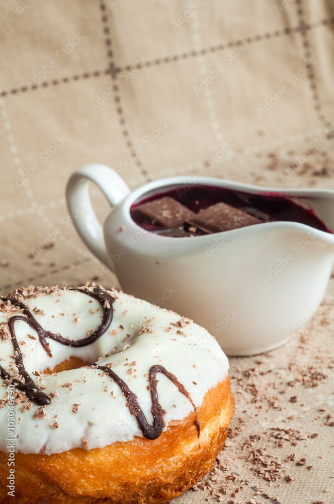 Fototapeta premium Donut with jam watered white chocolate. Dark chocolate, milk cho