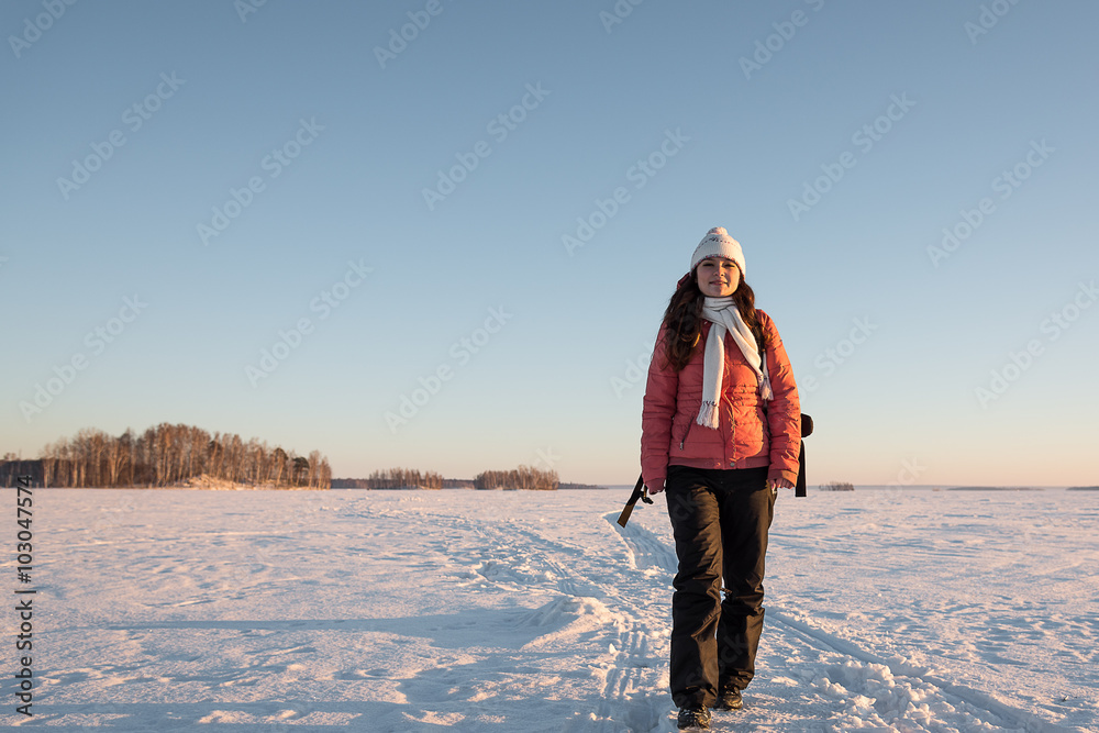 Portrait of beautiful woman with camera on winter snow day