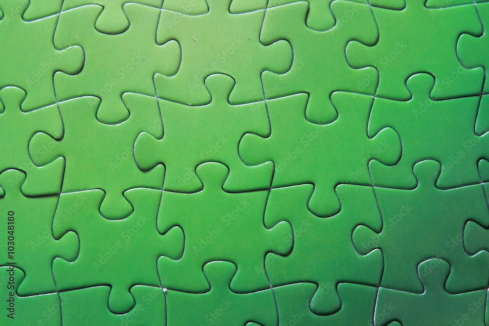 Detail of green puzzle pieces put together Detail of green puzzle pieces put together