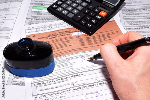 Polish personal income tax forms with a calculator and a pen photo
