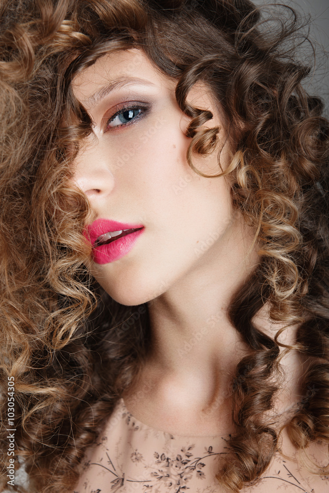 Portrait of beautiful girl in the studio with curly hair, closeup Portrait of beautiful girl in the studio with curly hair, closeup