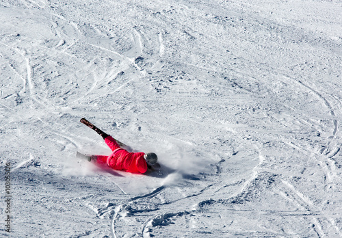 Woman riding on skis fall down