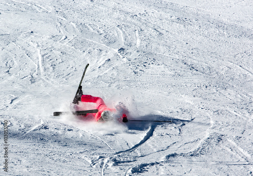 Woman riding on skis fall down
