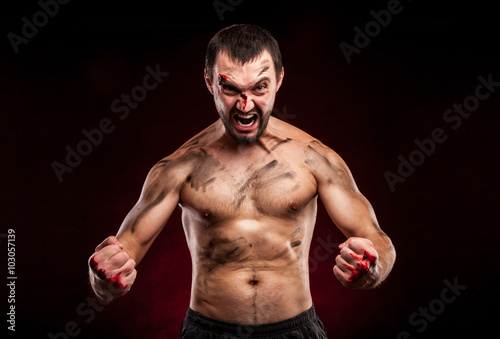Fighter man. Boxer with blood on face and body. Aggressive man 