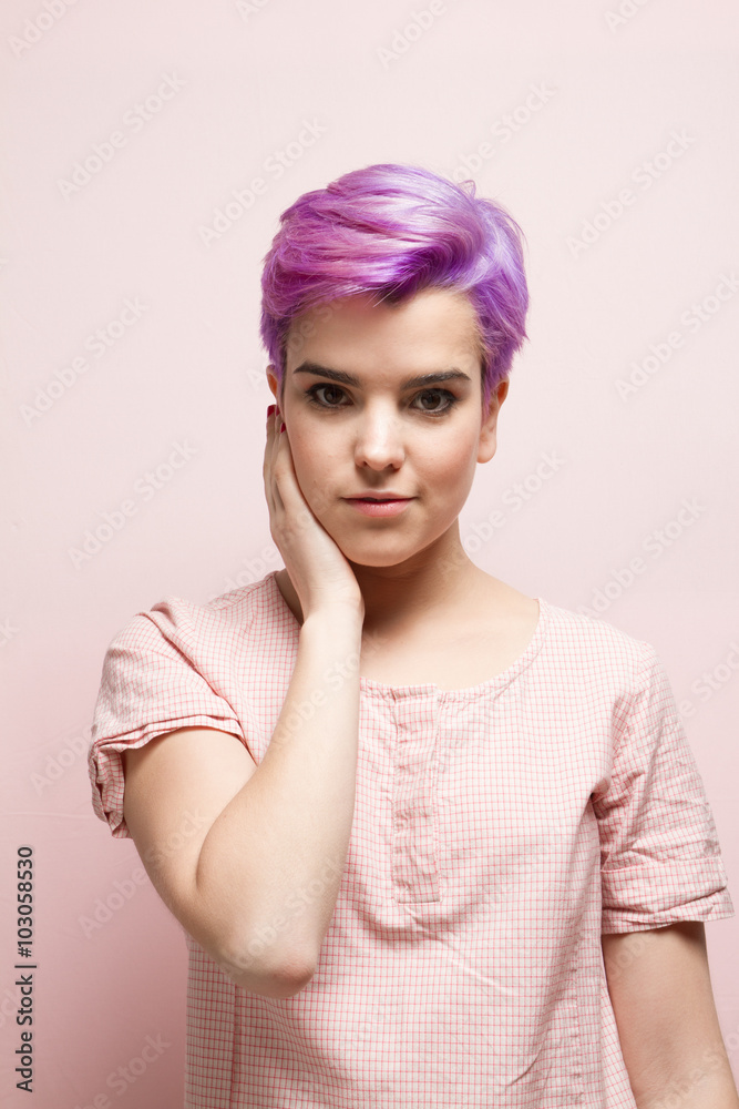 Violet-short-haired woman in pink pastel holding her face. Violet-short-haired woman in pink pastel holding her face.