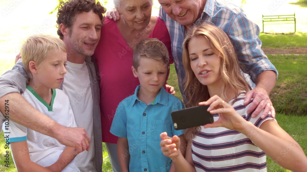 Happy family taking a selfie in the park Happy family taking a selfie in the park
