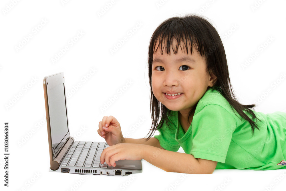 Chinese little girl lying down with laptop Chinese little girl lying down with laptop